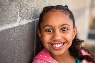 A calm, smiling child